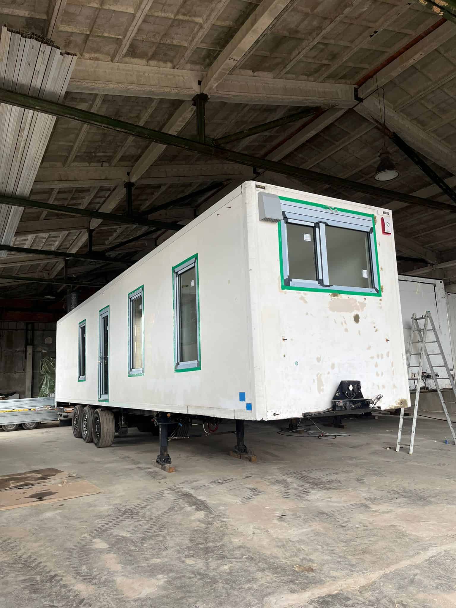 SEFR Home refrigerated trailer tiny house conversion windows door taped triple-axle chassis warehouse