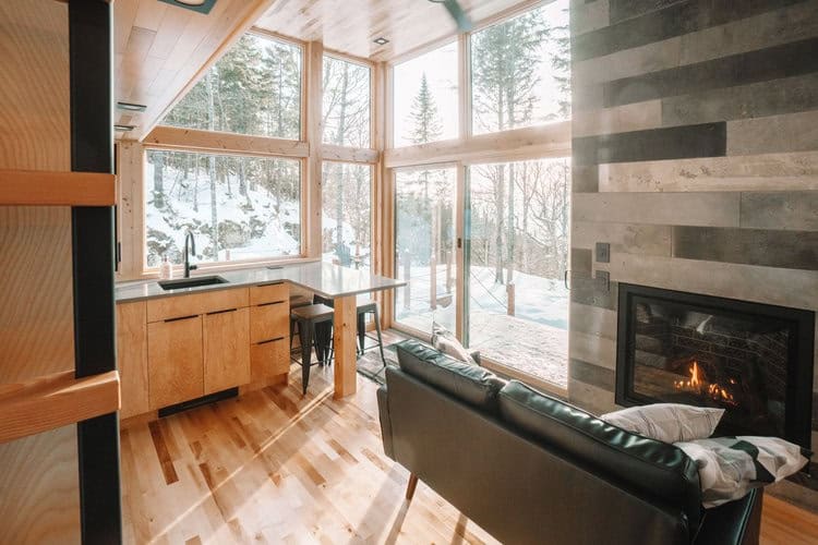 Prefab SKALI tiny house interior with large windows and modern design.