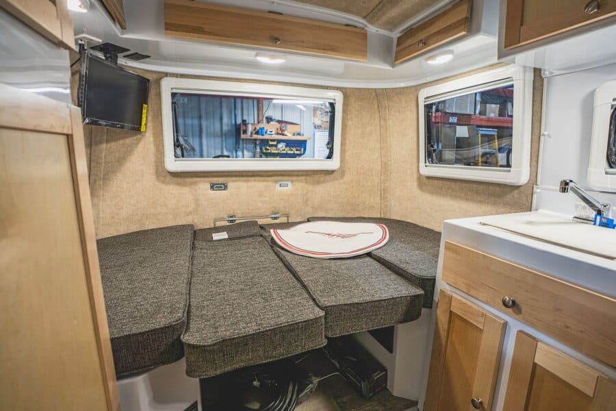 Rear dinette made up as a bed below a TV