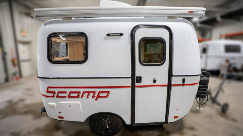 White Scamp 13 with red stripes in a showroom