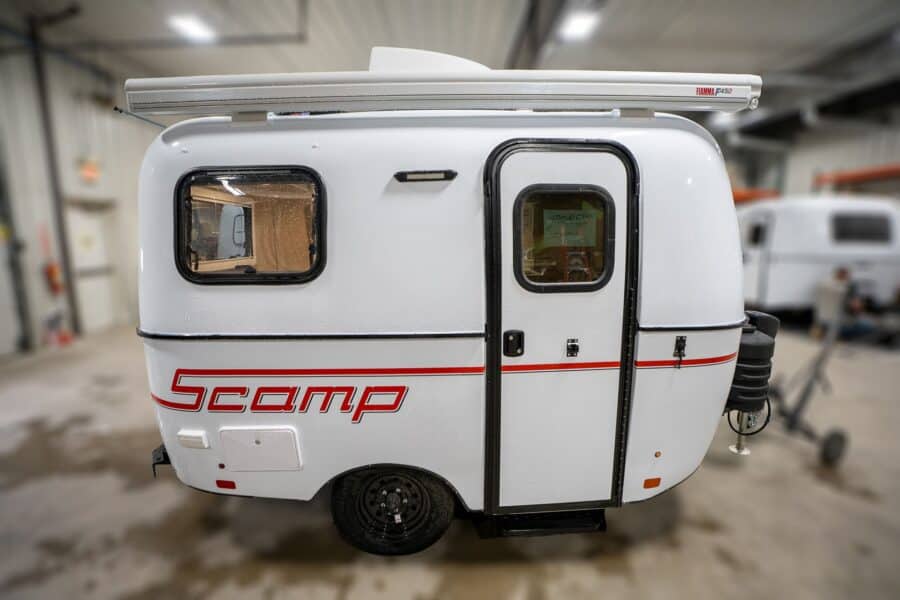 White Scamp 13 with red stripes in a showroom