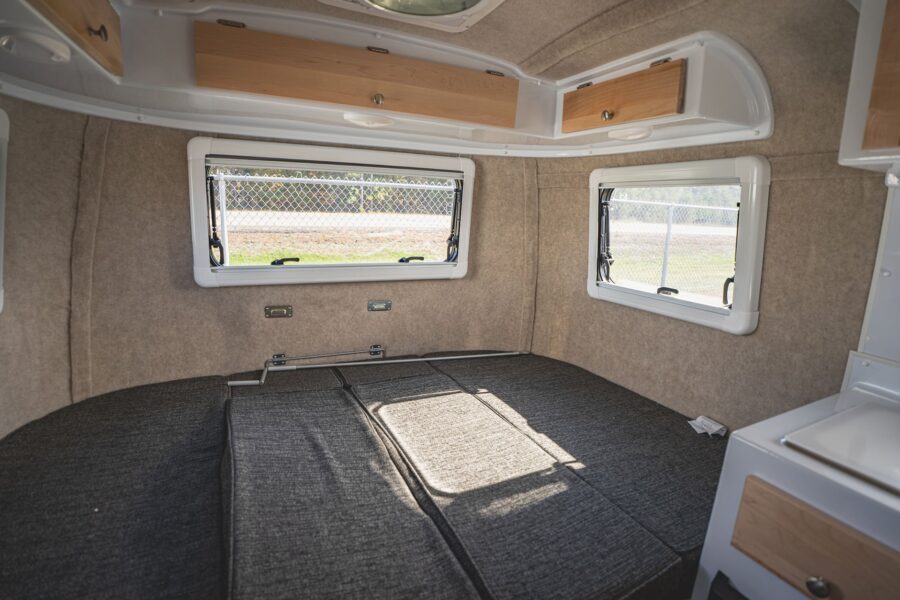 Wide rear bed made up below three windows