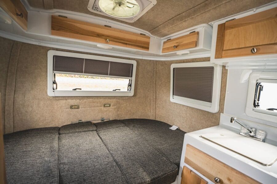 Rear dinette made up as a bed below three windows