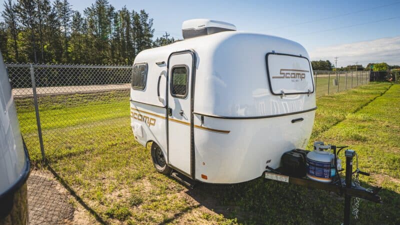 White Scamp 13 with a roof A/C on a grassy lot