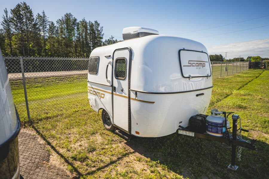 White Scamp 13 with a roof A/C on a grassy lot