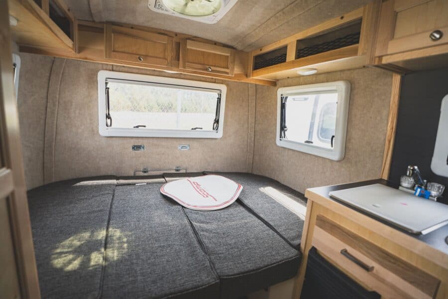 Rear dinette made up as a bed below three windows