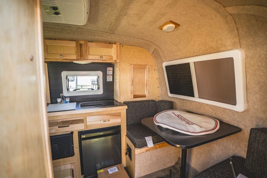 Galley and front dinette with a round table cover