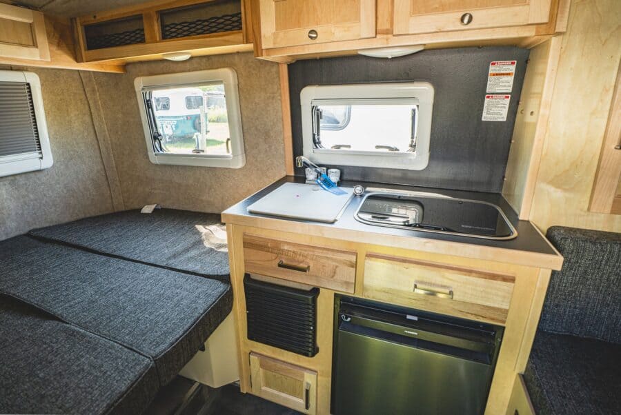Galley sink and refrigerator with maple cabinets