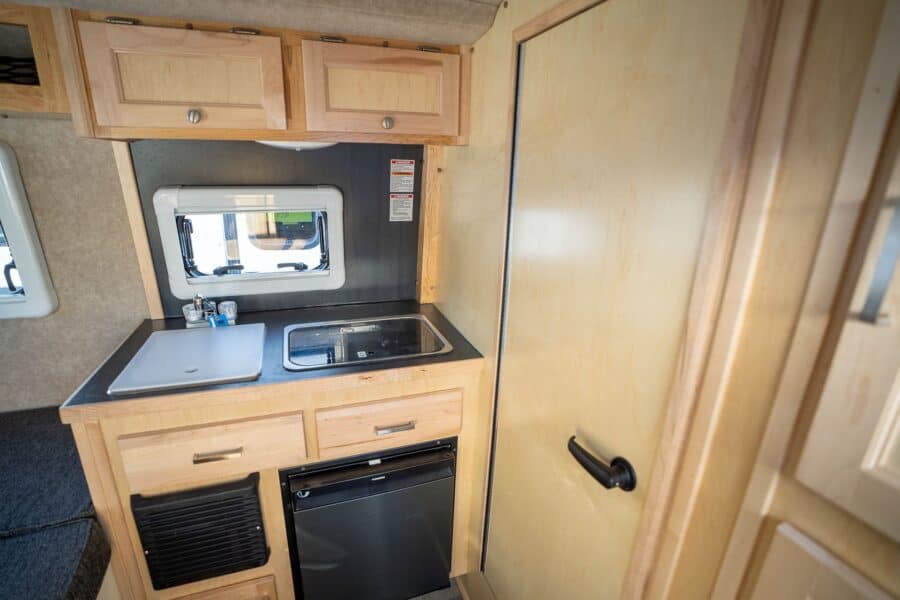 Galley sink and refrigerator beside the entry door