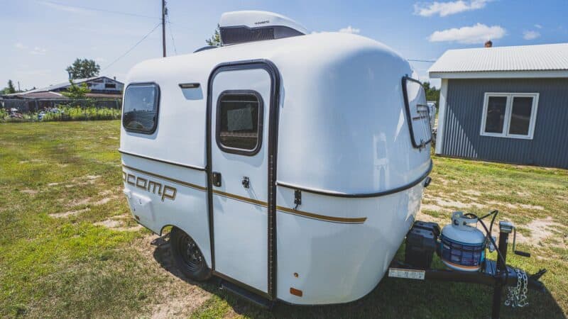 White Scamp 13 with a roof A/C on a grassy lot
