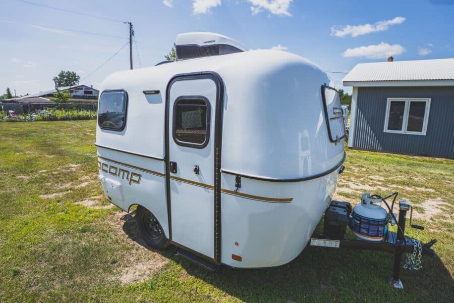 White Scamp 13 with a roof A/C on a grassy lot