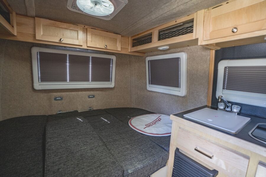 Rear bed made up below three windows