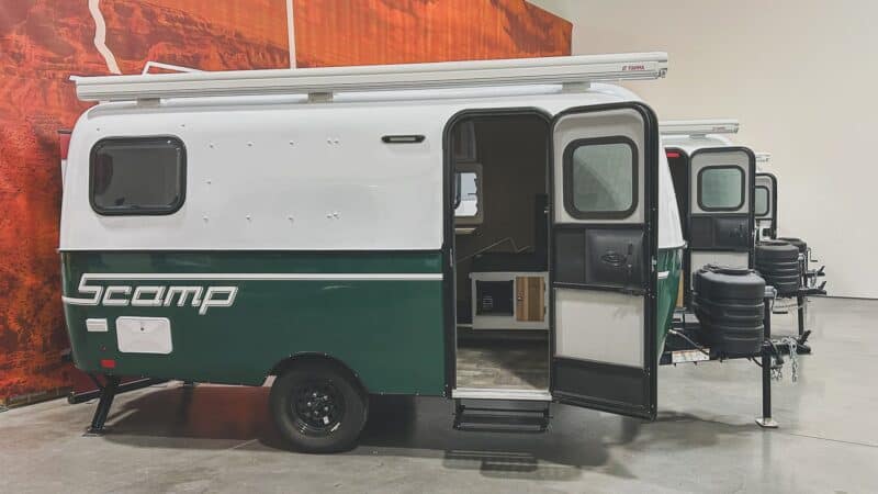 Scamp 16 with a moss green lower shell and open door in a showroom