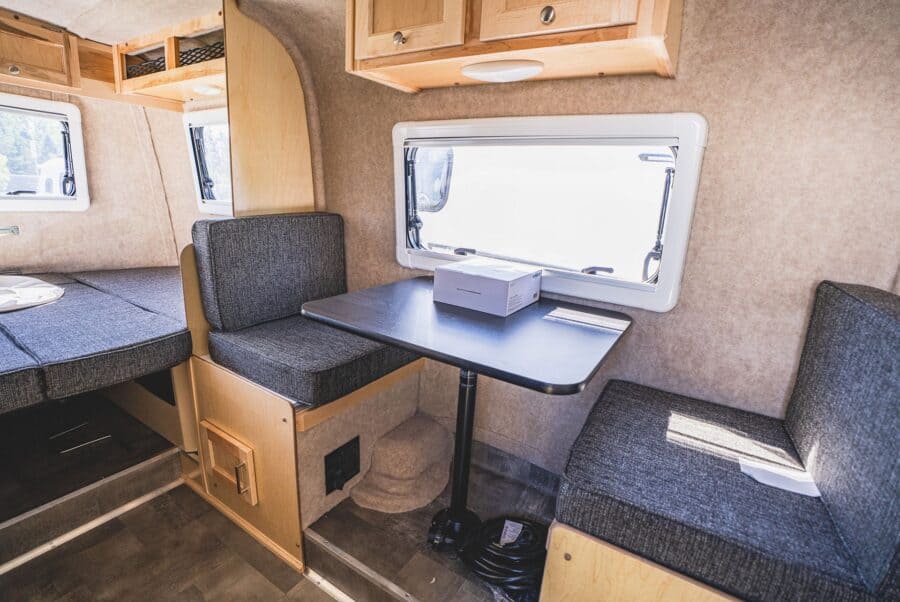 Side dinette with a black table across from the galley