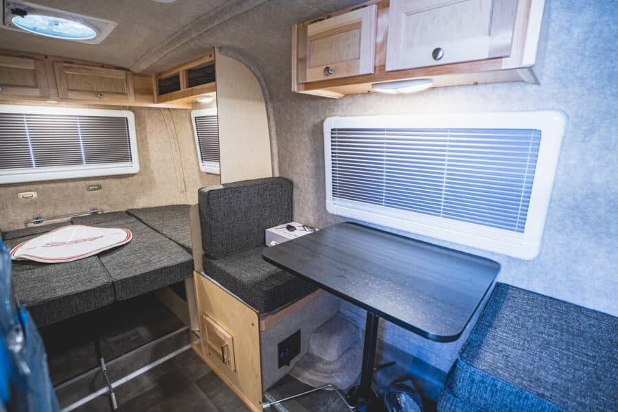 Side dinette and rear bed under a skylight vent