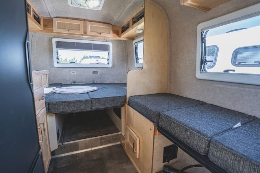 Rear bed and side dinette below the windows