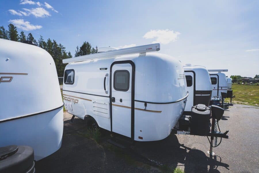 White Scamp 16 on a lot next to other trailers
