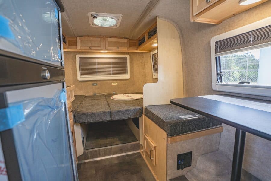 Rear bed and side dinette next to the refrigerator