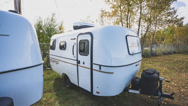 White Scamp 16 on a grassy lot under trees