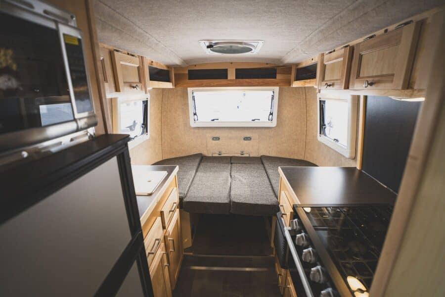 View toward the rear dinette past the galley and refrigerator
