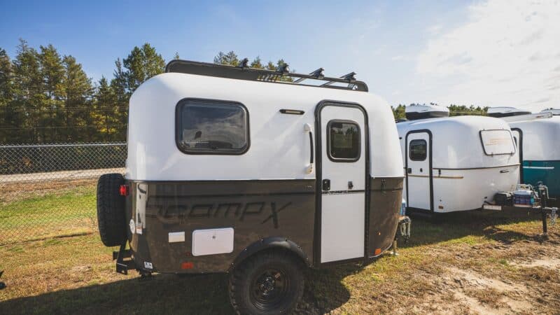 Scamp X with a dark grey lower shell and off-road tires on a lot