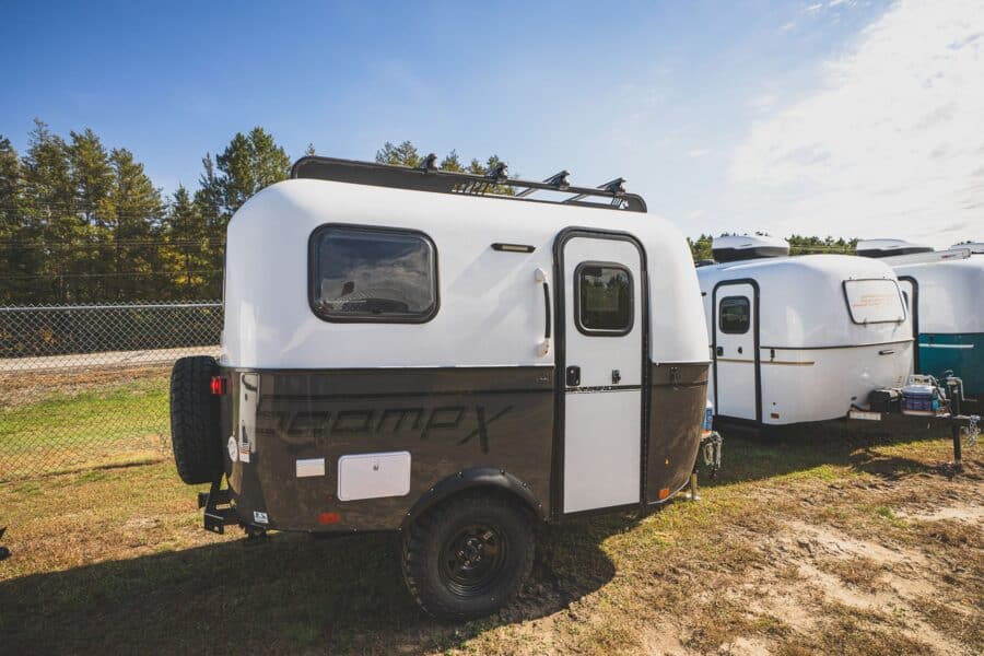 Scamp X with a dark grey lower shell and off-road tires on a lot