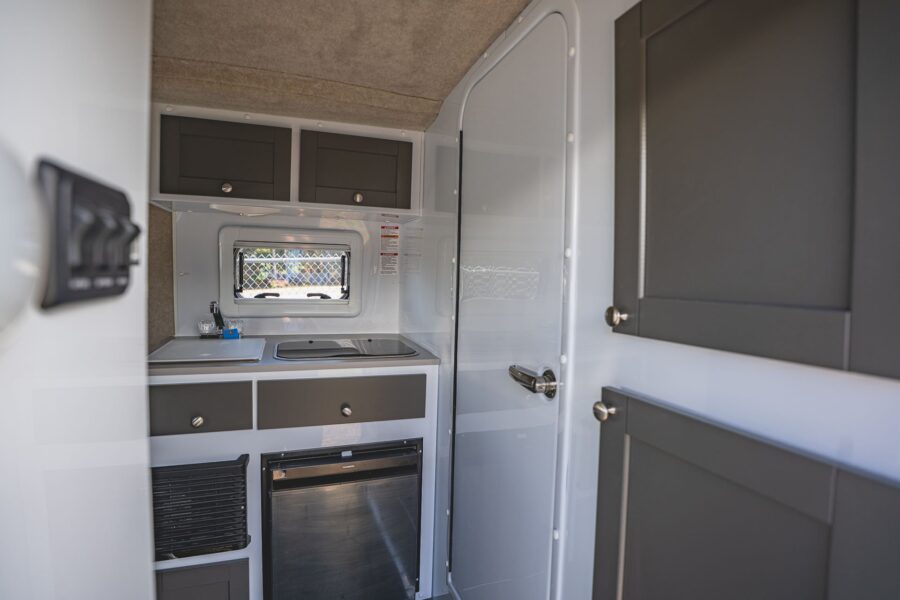 Grey and white galley next to the bathroom door
