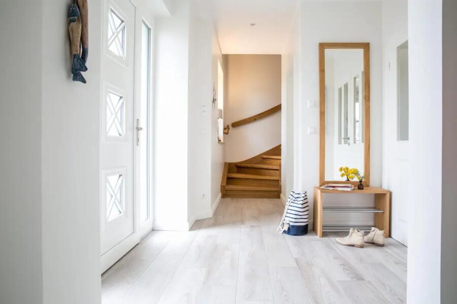 Cozy entrance of a small German cottage guesthouse with minimalist decor and natural light.
