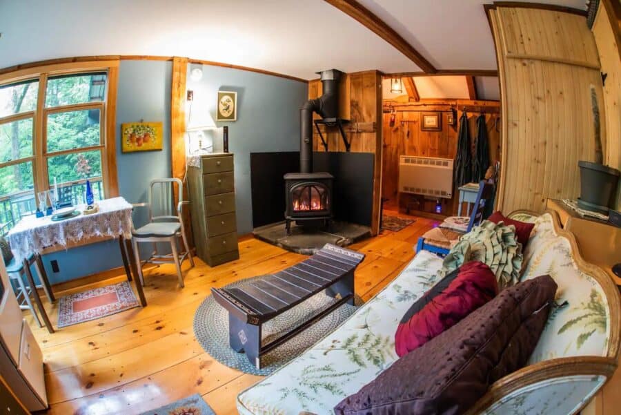 Charming romantic cabin in Vermont with a warm fireplace and rustic wooden decor. Perfect for a peac.