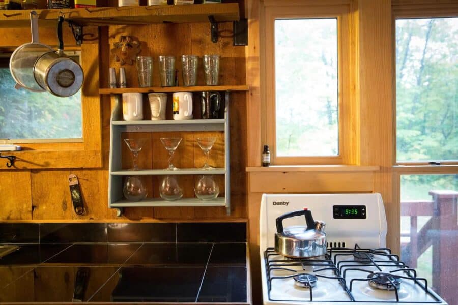 Charming rustic kitchen in a romantic Vermont cabin with wooden accents and modern appliances.