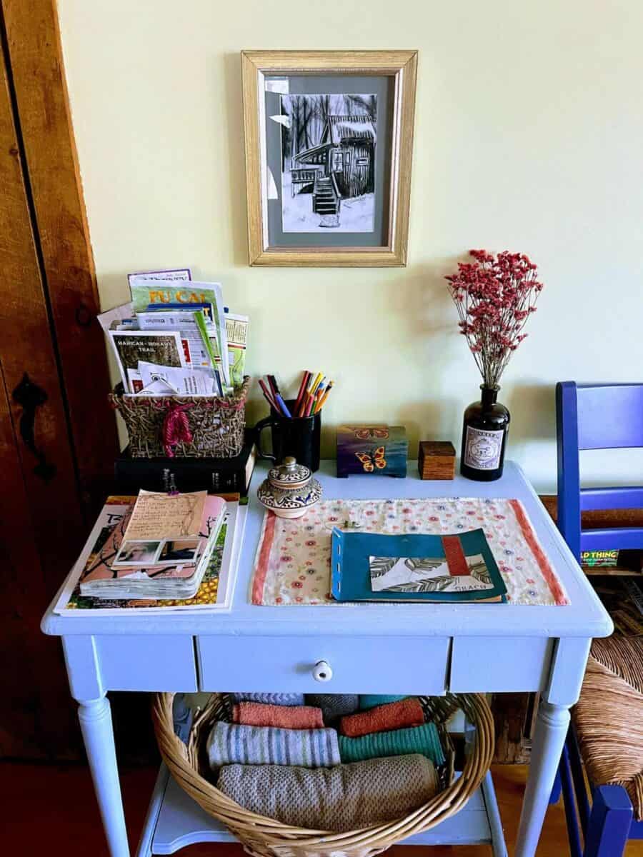 Charming Vermont cabin interior with a small desk, books, and decorative accents.