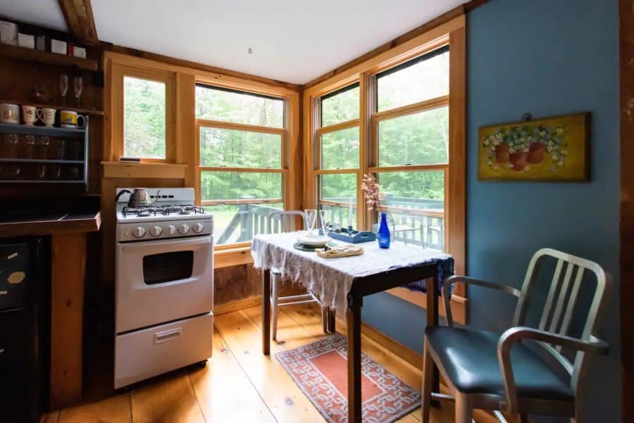 Bright kitchen with large windows in a Vermont cabin.