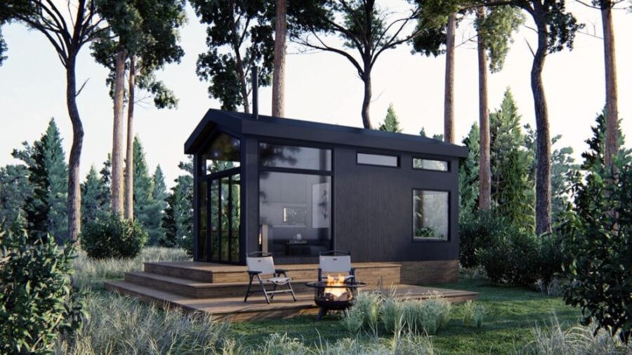 Compact ShadowPine Cabin with modern design in a lush wooded area.