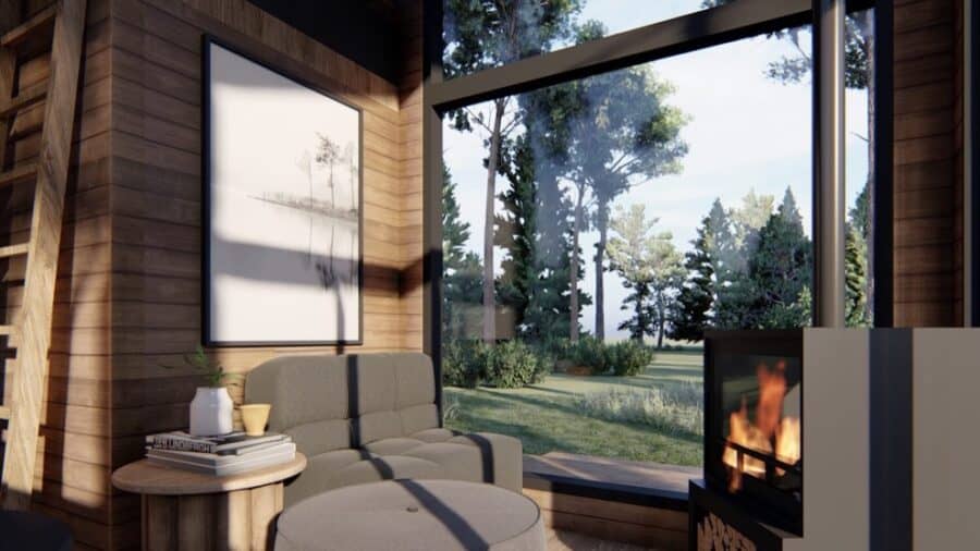 Bright interior of ShadowPine Cabin with large windows and modern fireplace.