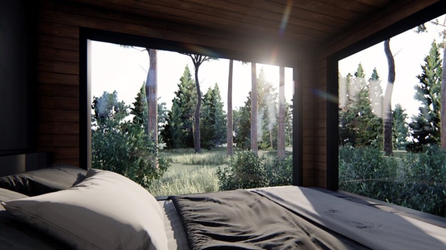 Interior view of the ShadowPine Cabin with large windows and natural forest scenery.