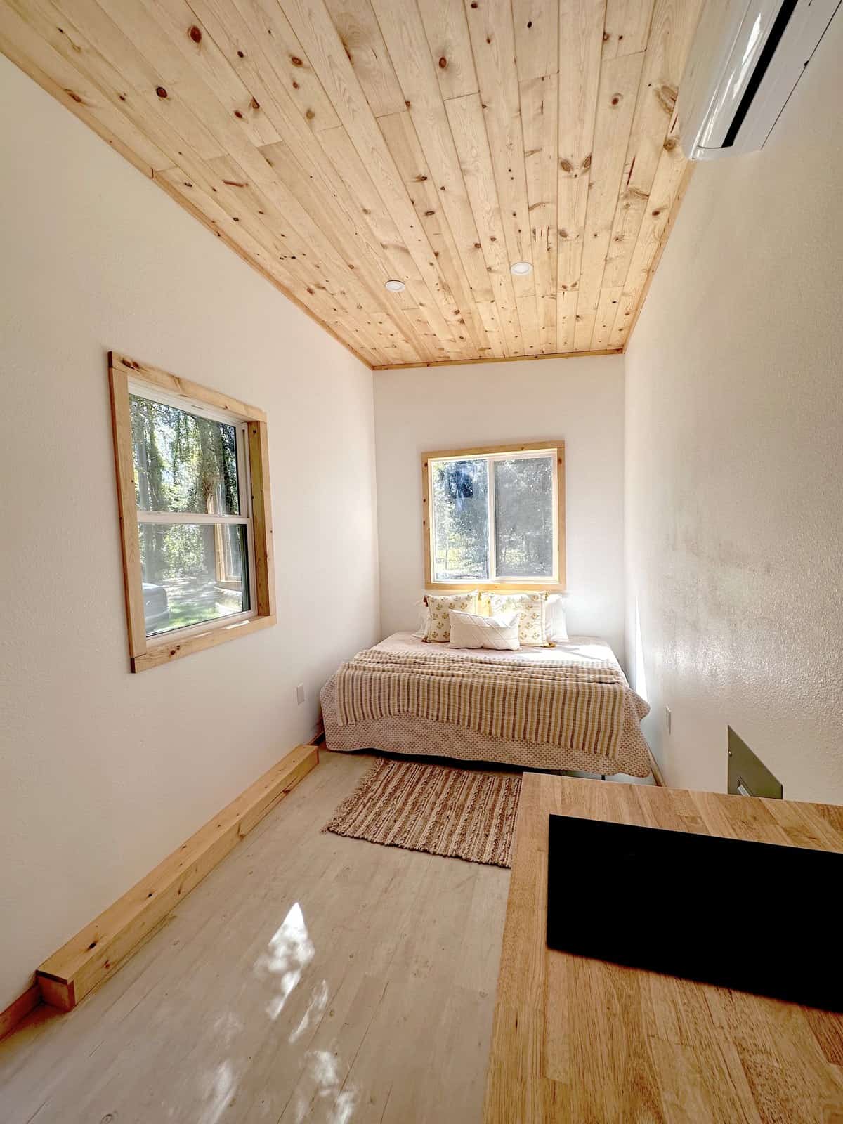View from the Shanti kitchen toward the ground-level queen bedroom, showing the wide-open floor plan with no stairs