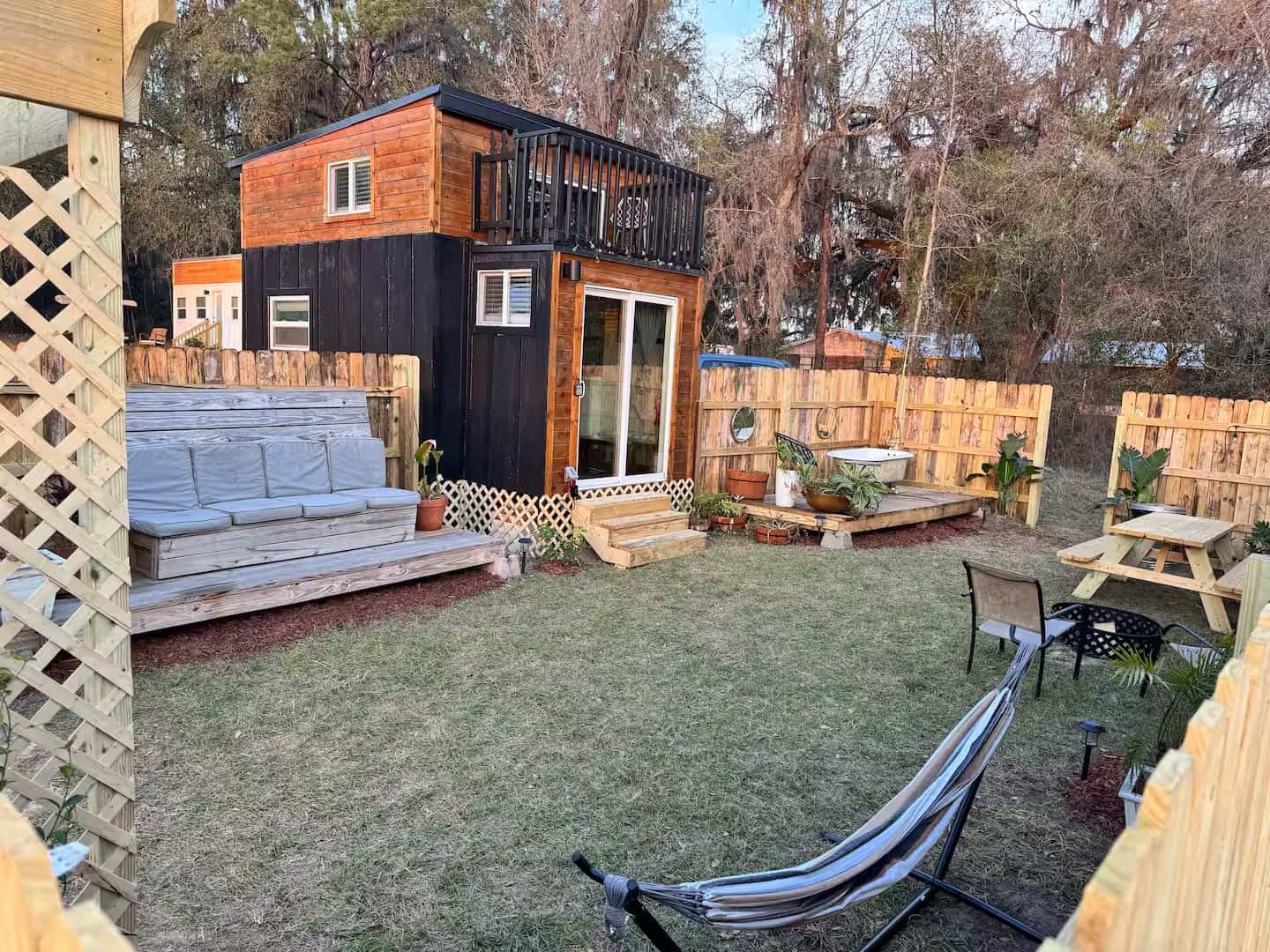 Backyard fire pit, hammock, and outdoor seating at the Shiva tiny home