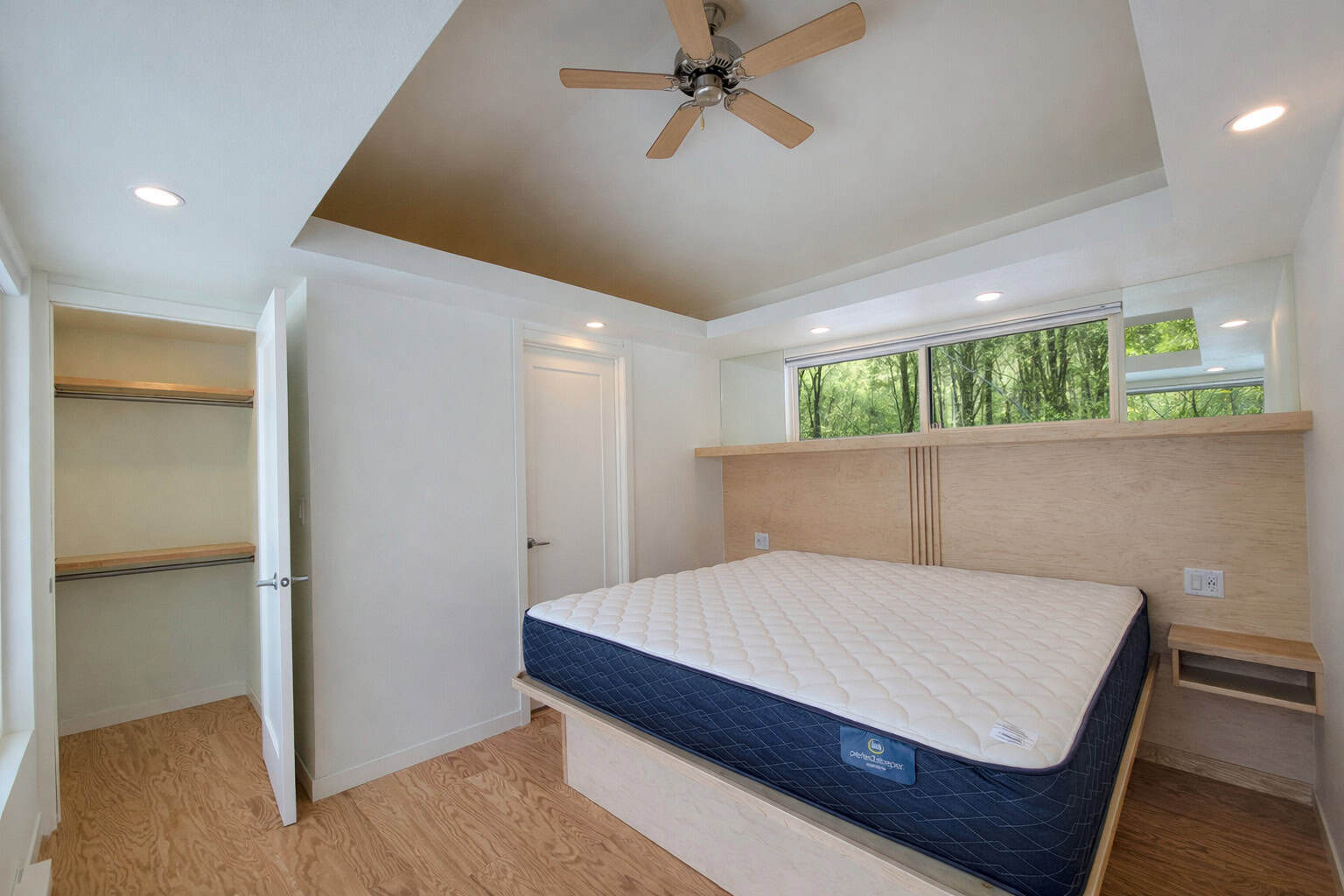 SHORELINE Glass House king bedroom with walk-in closet and vaulted ceiling