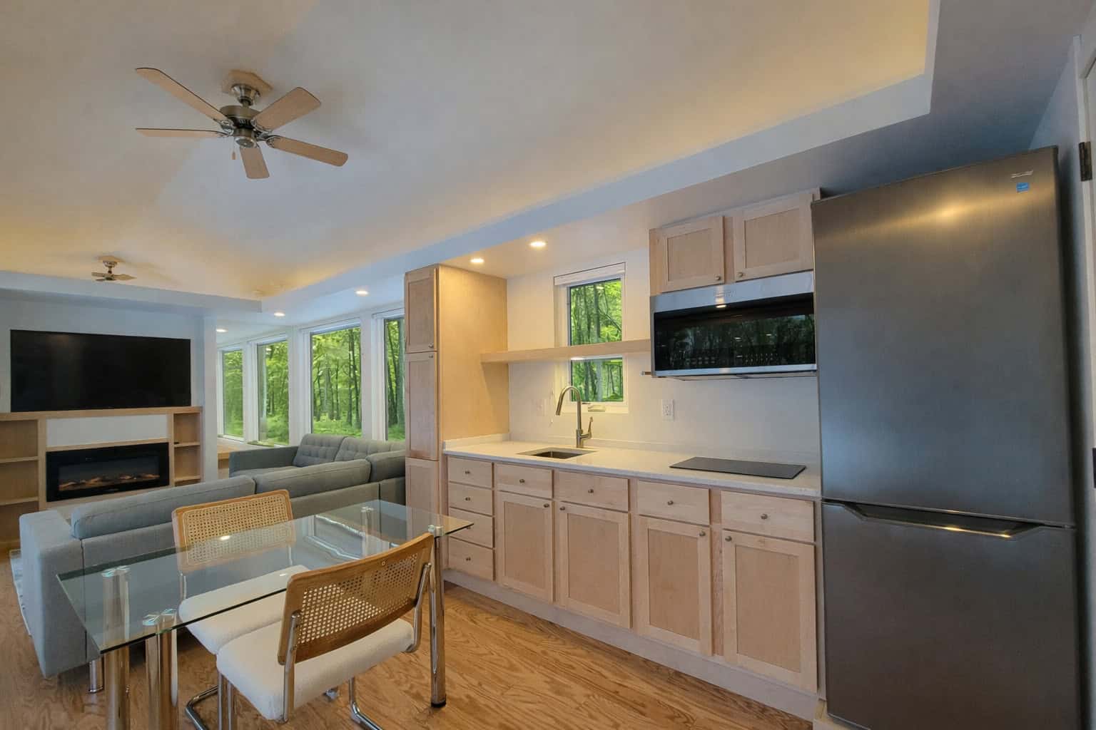 SHORELINE Glass House gourmet kitchen with stainless steel appliances and ample cabinetry
