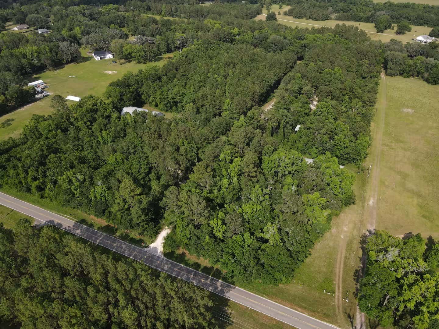 Aerial view of Simplify Further's wooded 14-acre tiny-home building property along the main road