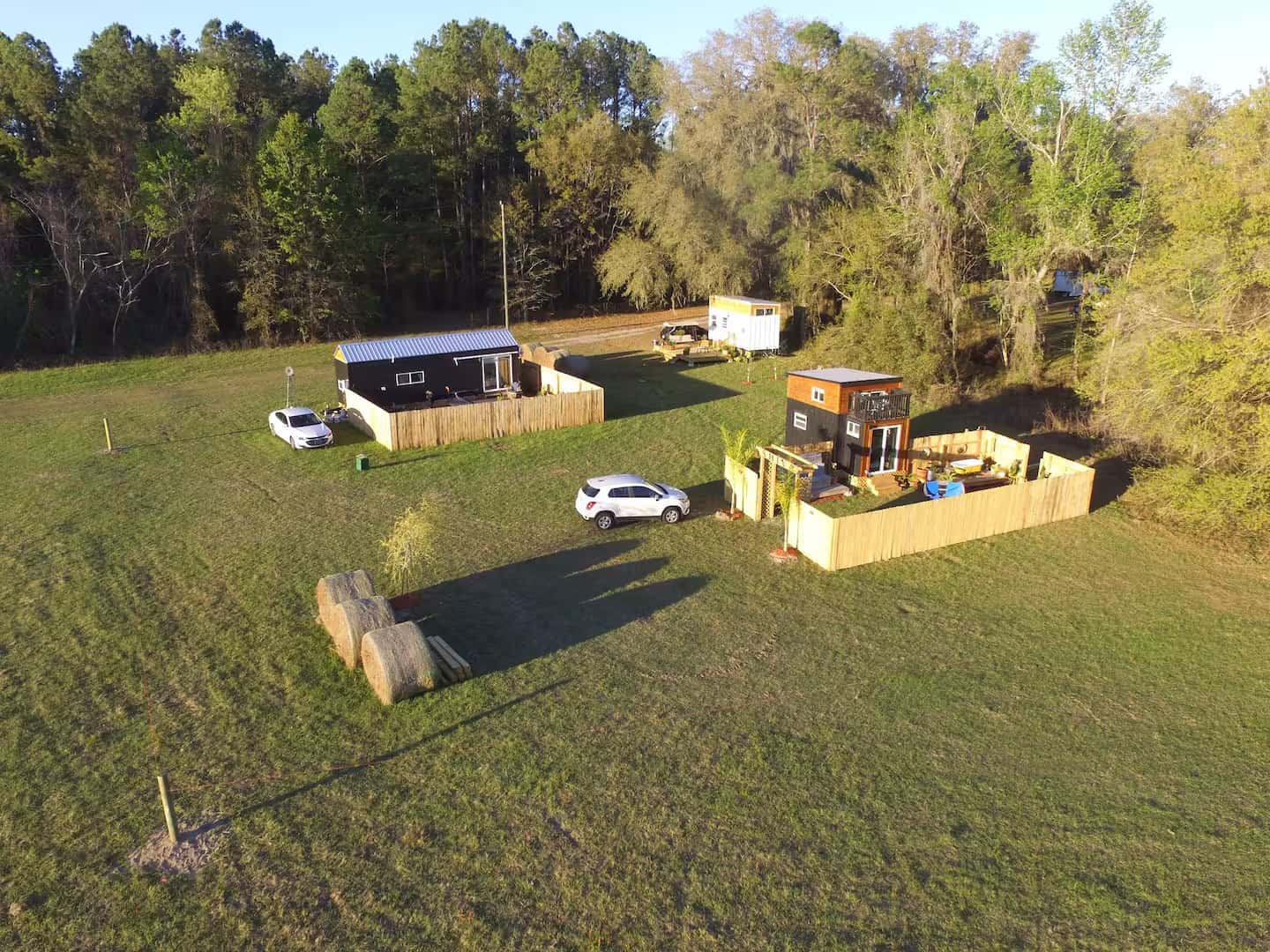 Aerial view of the Simplify Further tiny home property with several tiny houses among open fields