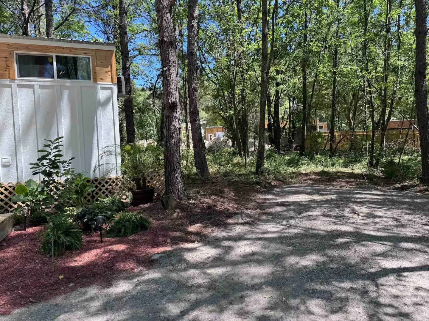 Other Simplify Further tiny homes visible through the trees on the shared property
