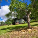 Tiny house on a lush green hillside in Queensland, Australia.