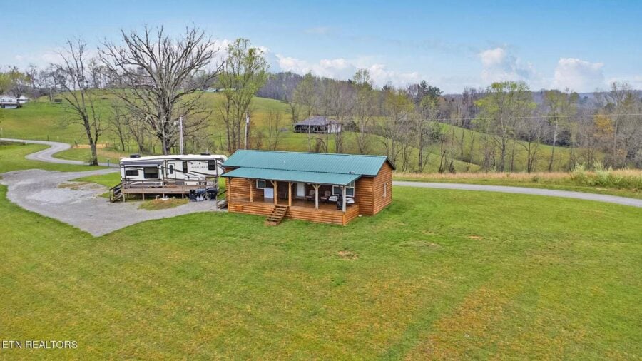 Tiny house on 12 acres in Tennessee with RV hookups and scenic countryside views.