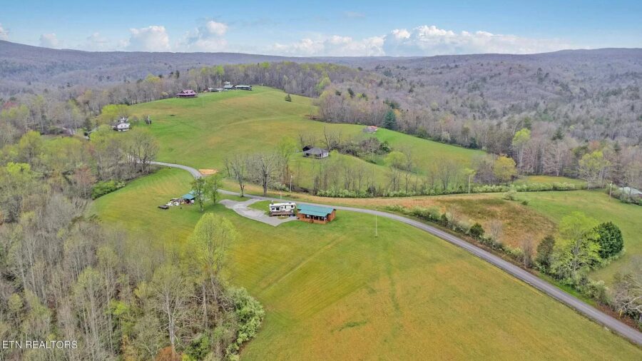 Small home on spacious 12-acre property with RV hookups in Tennessee.