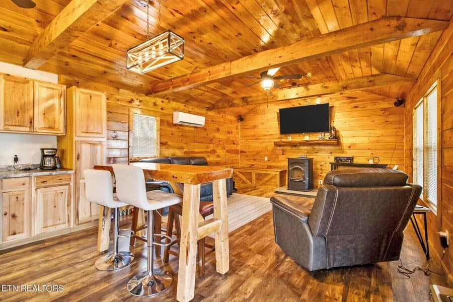 Interior of a small home with wood accents, a living area, and kitchen in Tennessee.