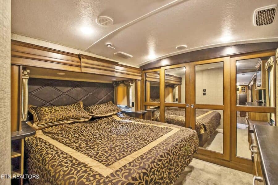 Comfortable bedroom in a tiny house with stylish bedding and warm lighting.