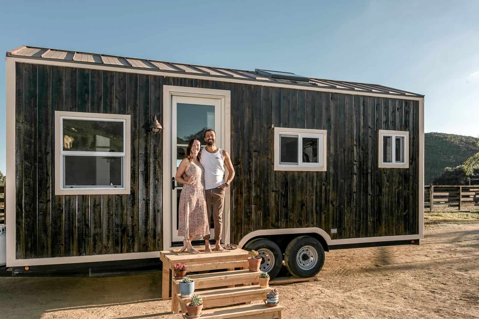 Spindrift Homes founders Bijan and Sarah standing outside one of their tiny homes