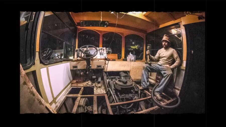 Interior view of a tiny house built inside a vintage trolley bus.
