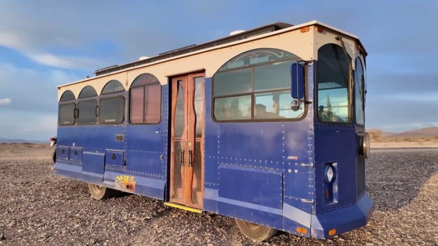 Vintage trolley converted into a cozy tiny home on wheels.